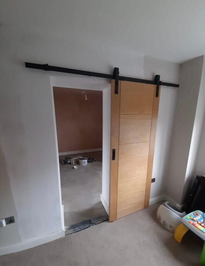 Sliding oak barn door in a completed Sutton Coldfield garage conversion